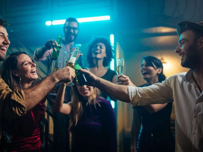 Group of young friends dancing together in the nightclub